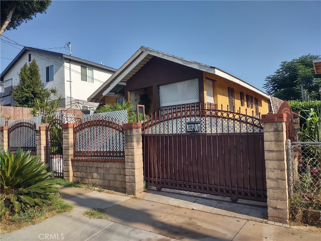 a view of a house with wooden fence