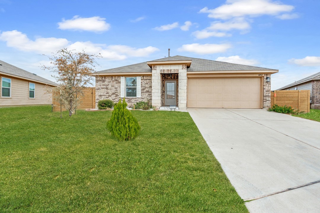 a front view of house with yard and green space