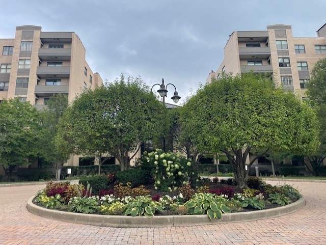 a front view of a multi story residential apartment building with a yard