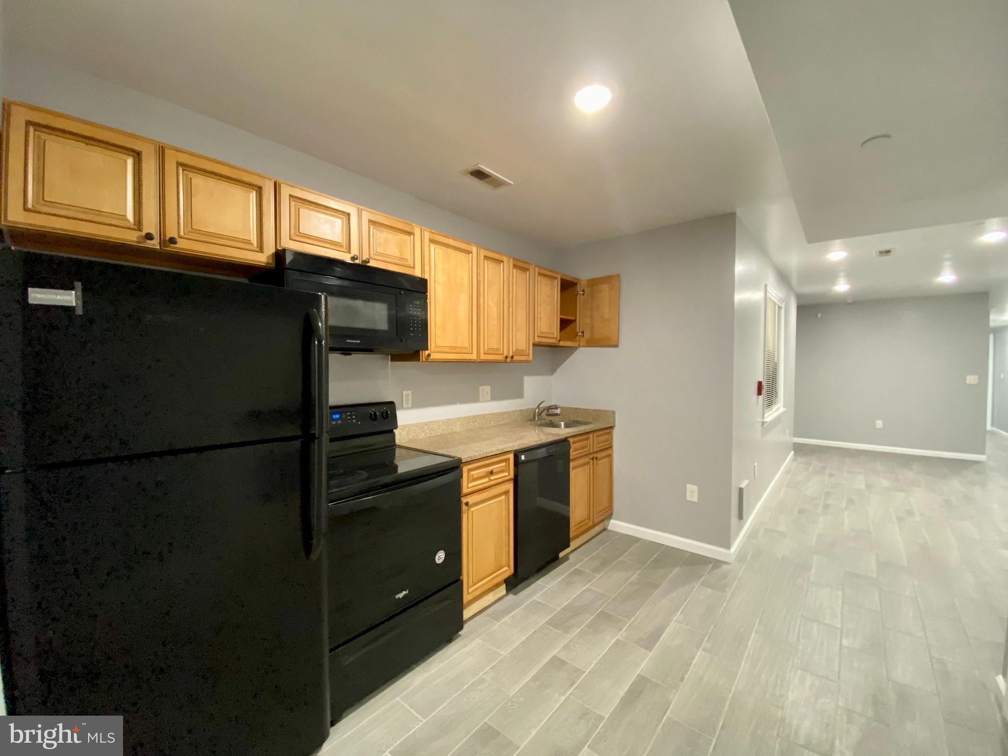 a kitchen with a refrigerator and a sink