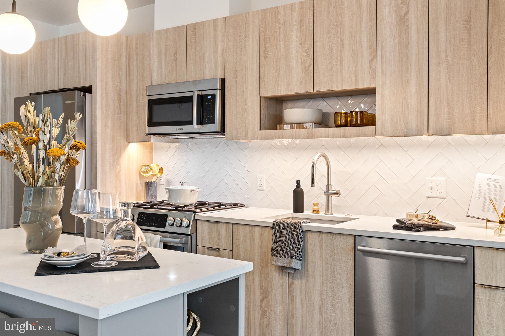 a kitchen with a sink stove and microwave