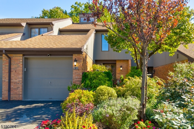 a view of a house with a flower garden