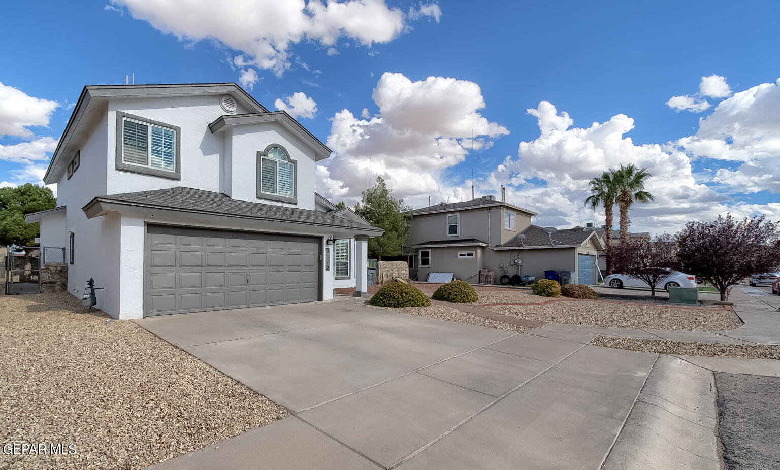 a view of a house with a yard and garage