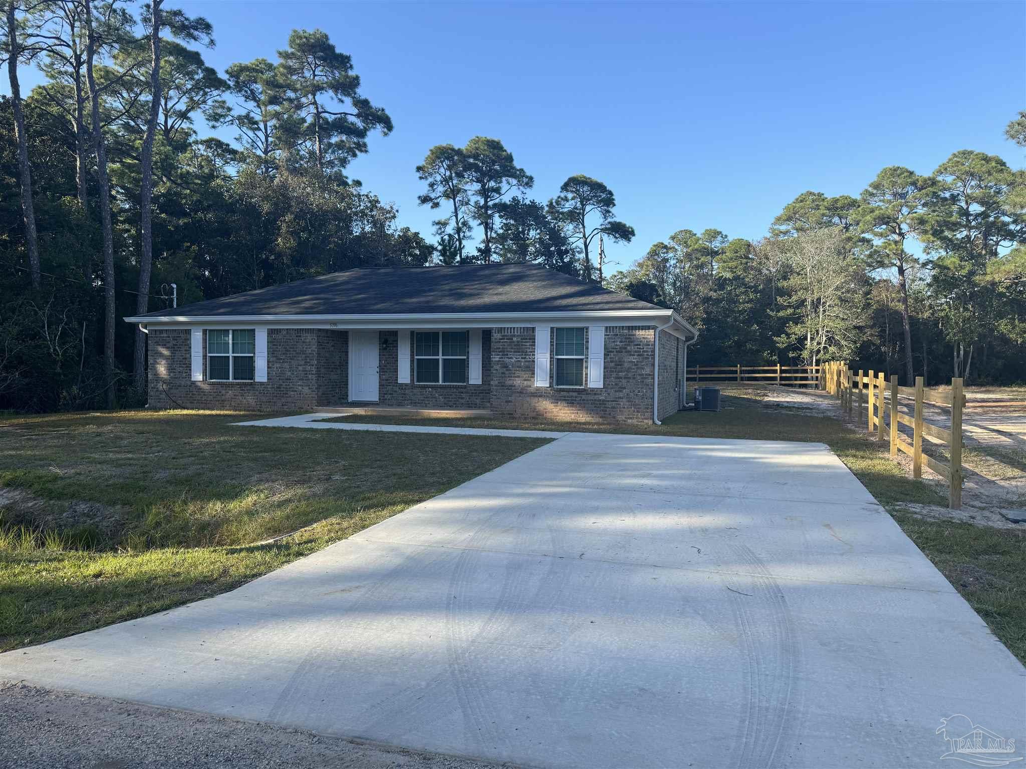 a view of house with yard in front of it