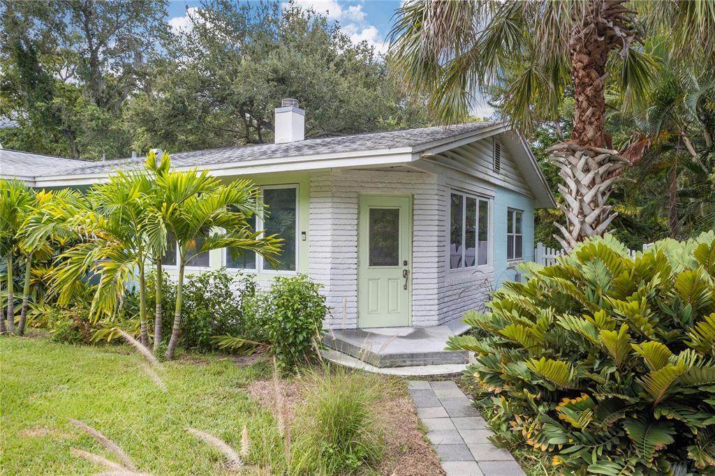 a view of a house with a yard and plants