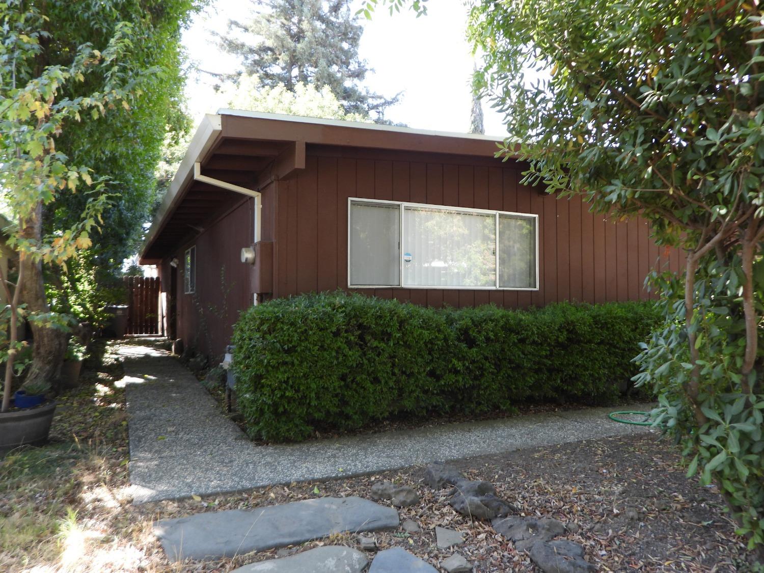 a front view of a house with garden