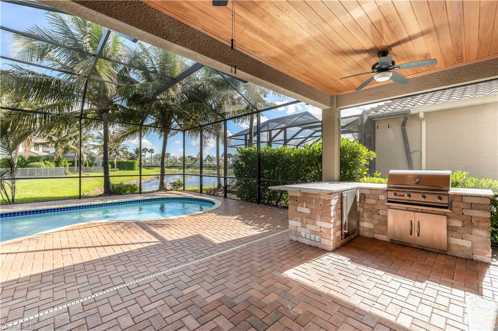 Covered lanai, built-in BBQ & bar, pool area.