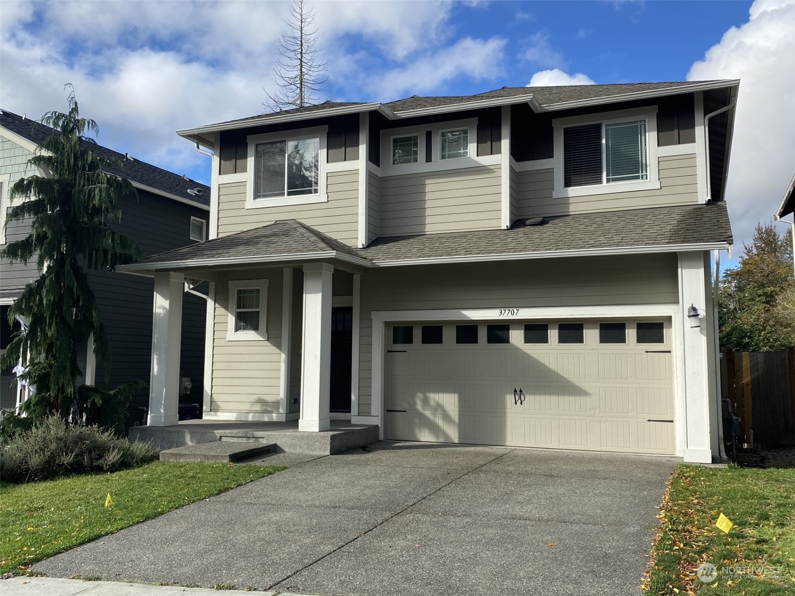 a front view of a house with a yard and garage