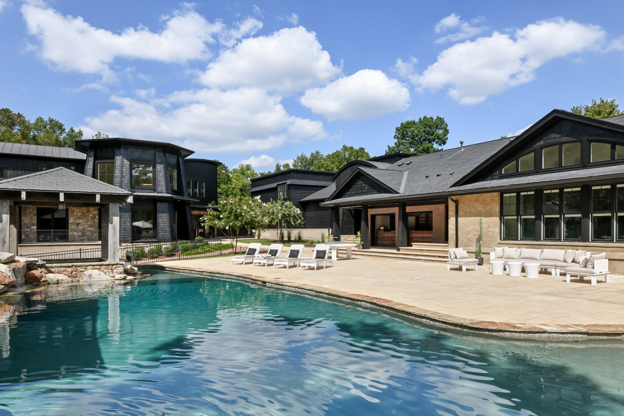 a view of a house with backyard and sitting area