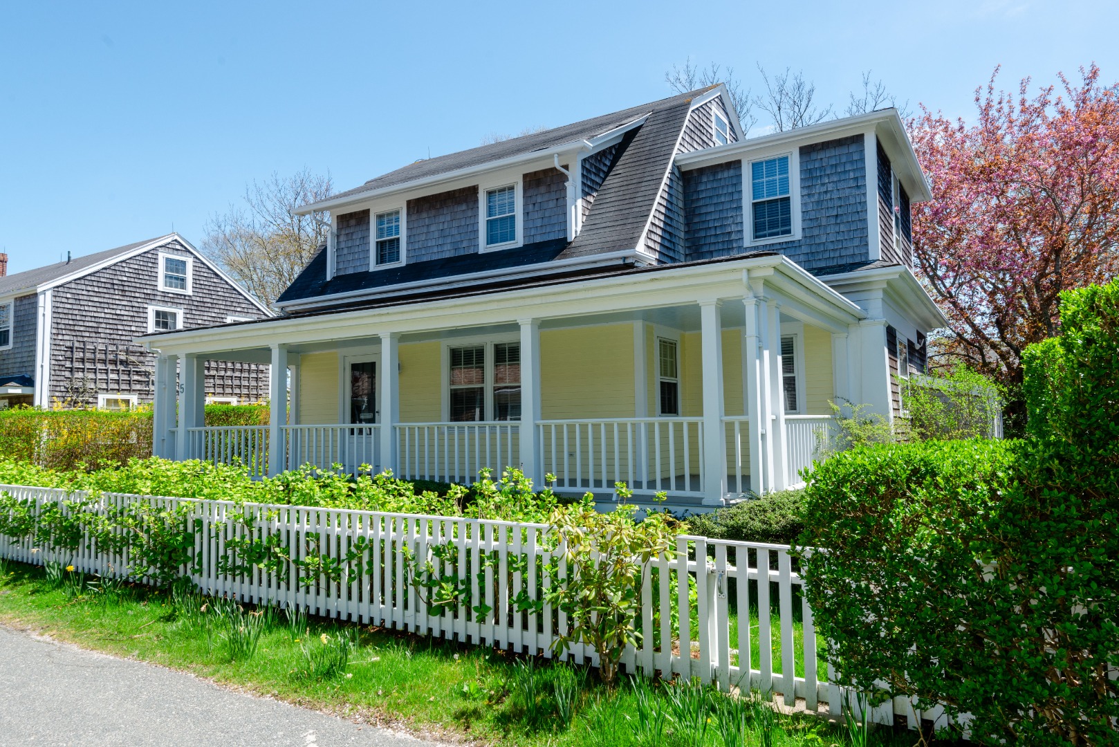 a front view of a house with a garden