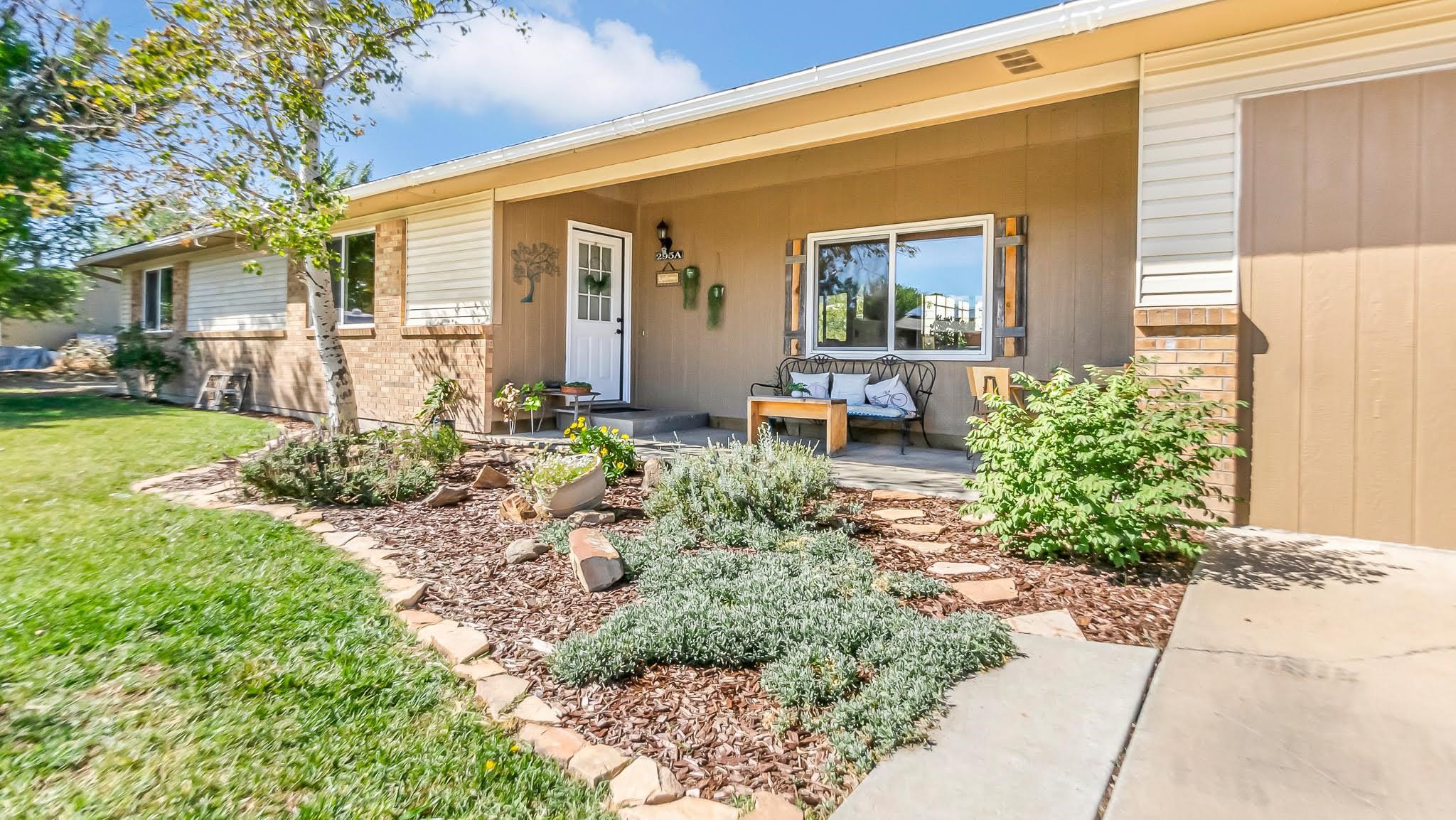 a view of a house with backyard and sitting area