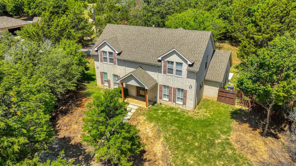 an aerial view of a house with a yard and potted plants