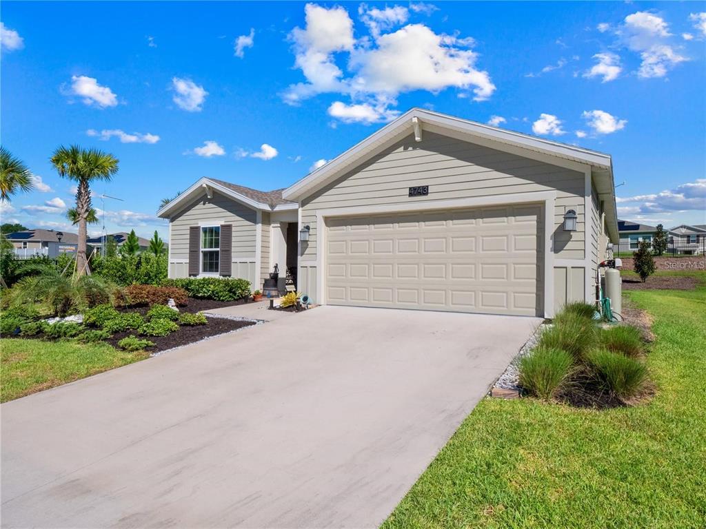 a view of a house with a yard and garage