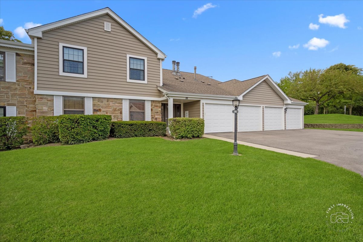 a front view of a house with a garden