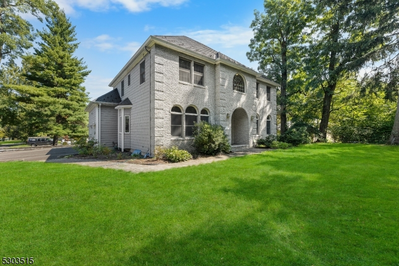 a front view of house with yard and green space