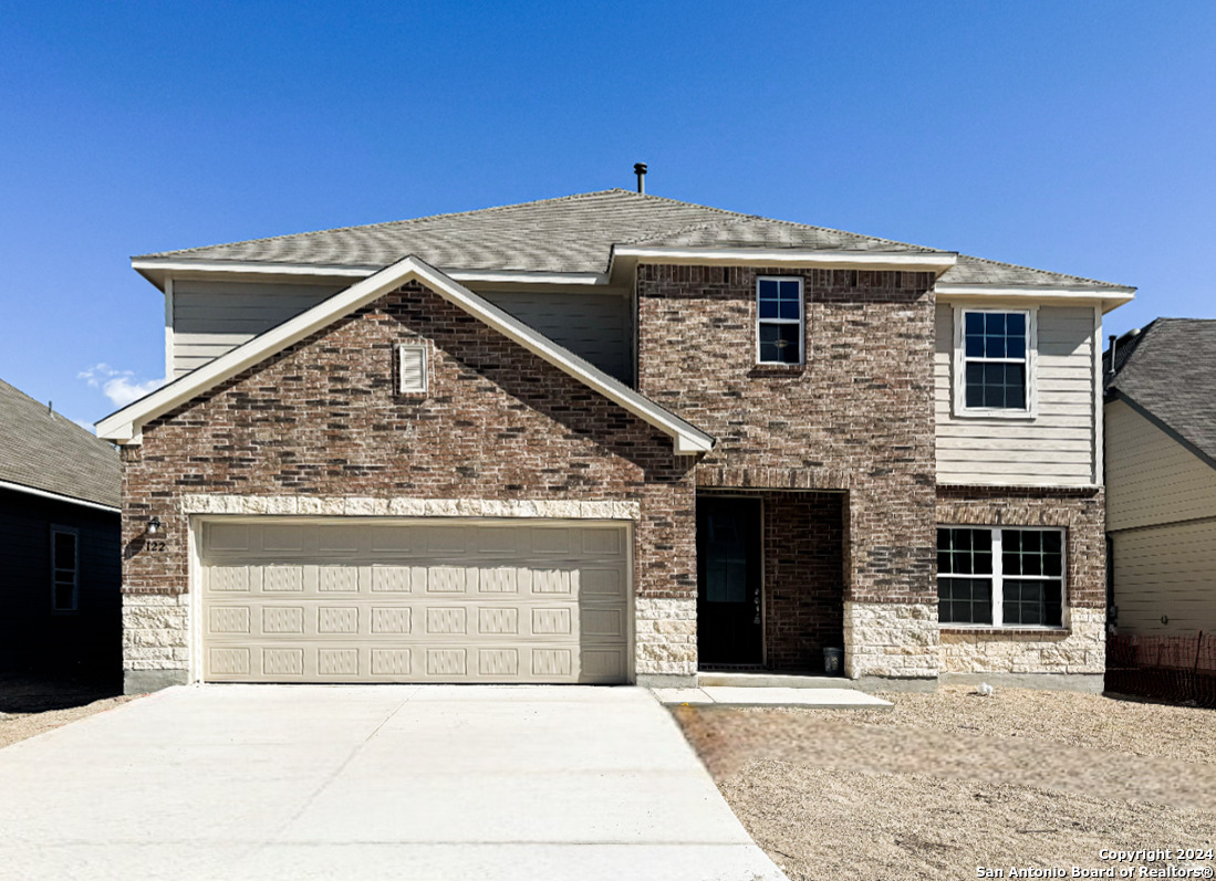 a front view of a house with a garage