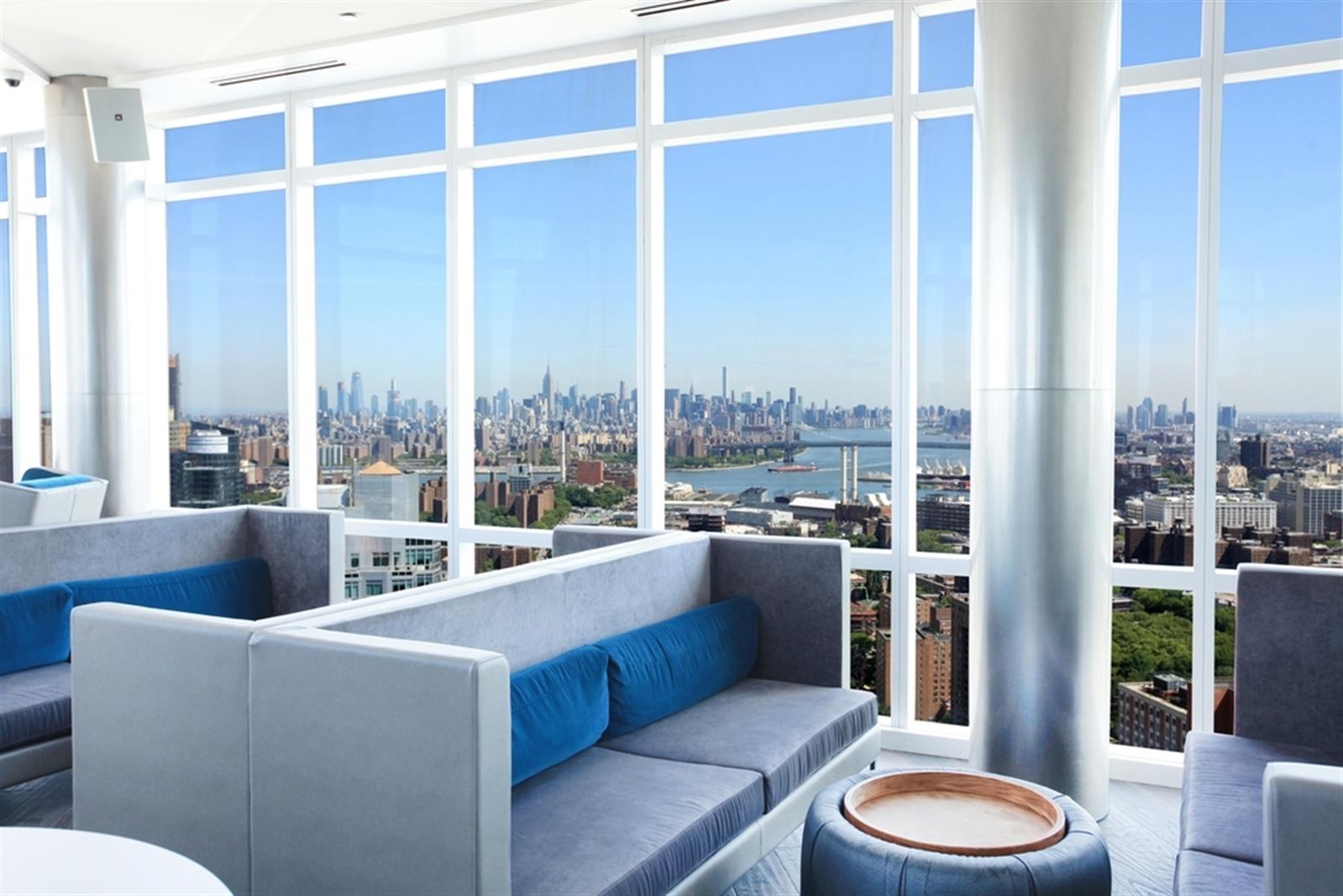 a living room with furniture and a floor to ceiling window