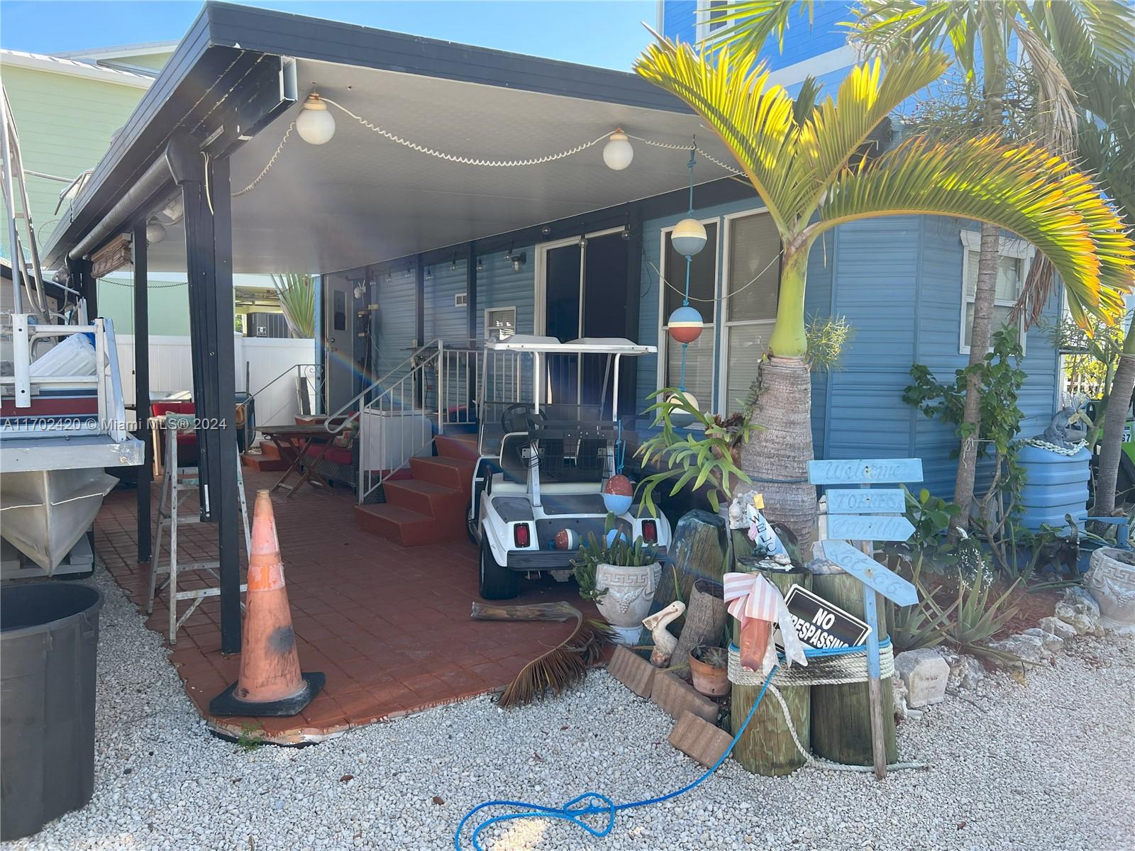 a view of a house with backyard porch and sitting area