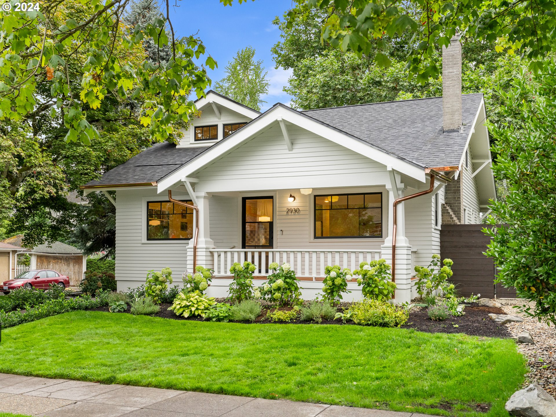 a view of a house with a yard and plants