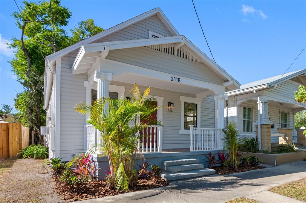 a front view of house with flowers