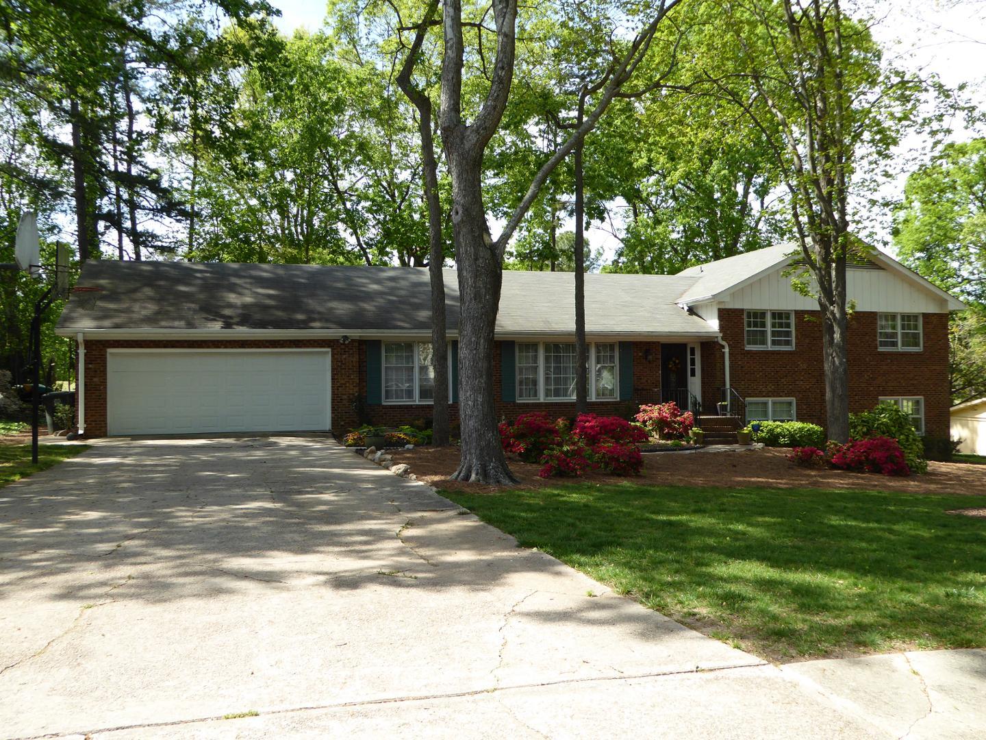 a front view of a house with yard patio and green space