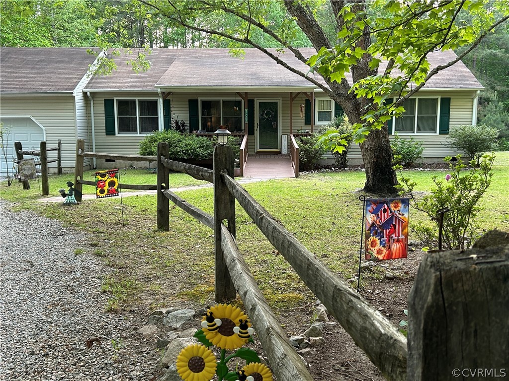 a front view of house with small garden and plants