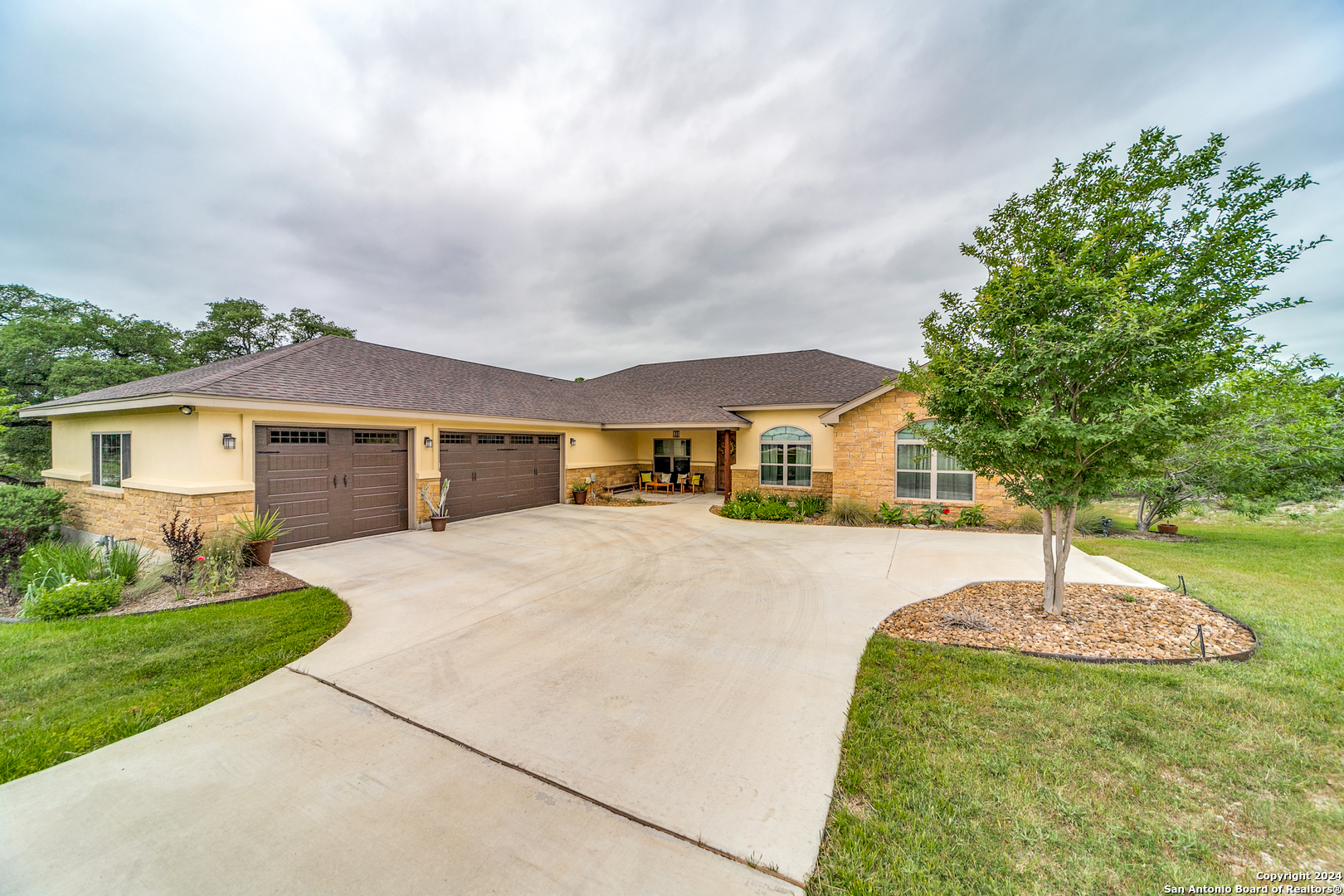 a front view of a house with a yard and garage