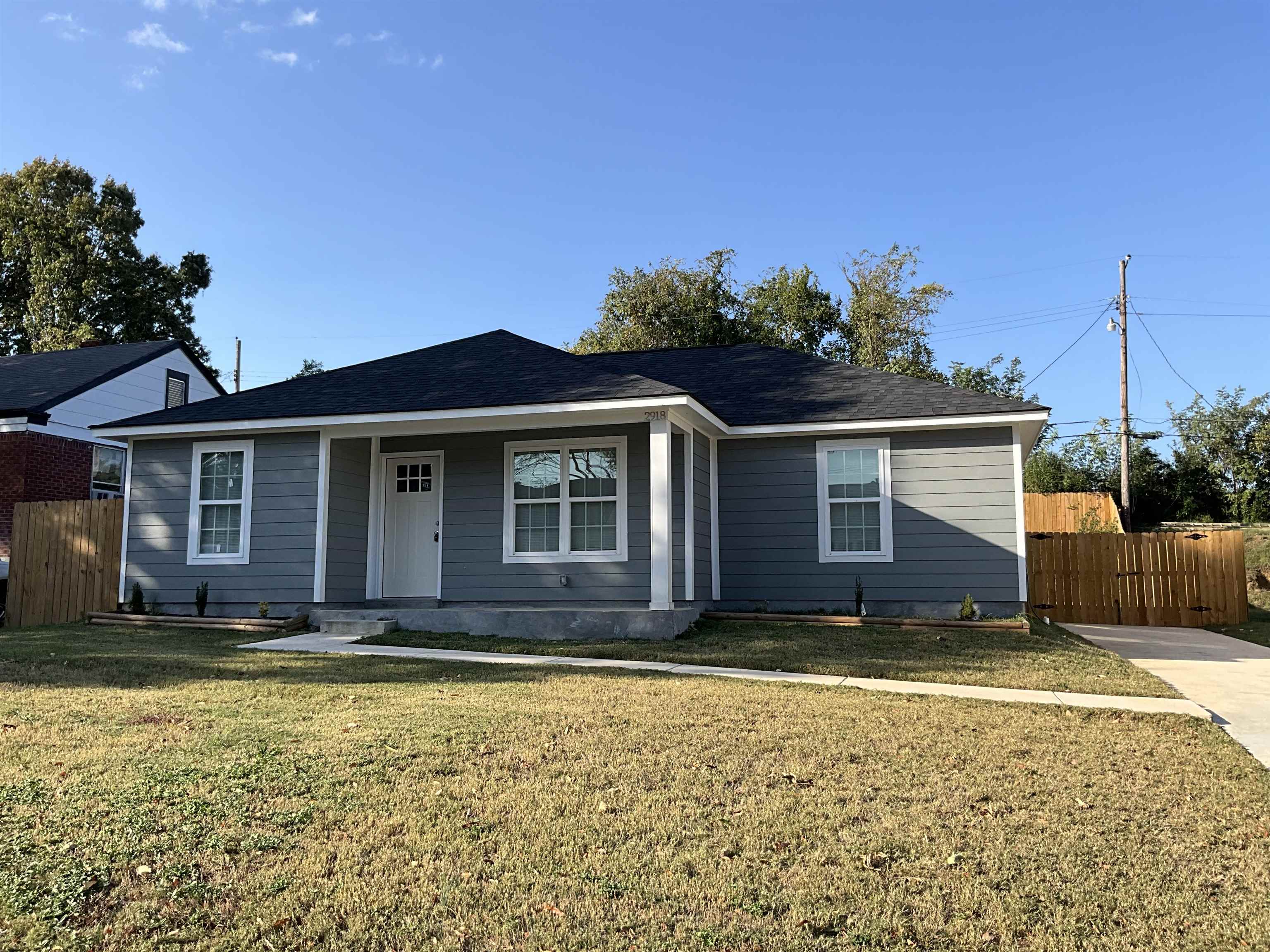 Single story home featuring a front lawn