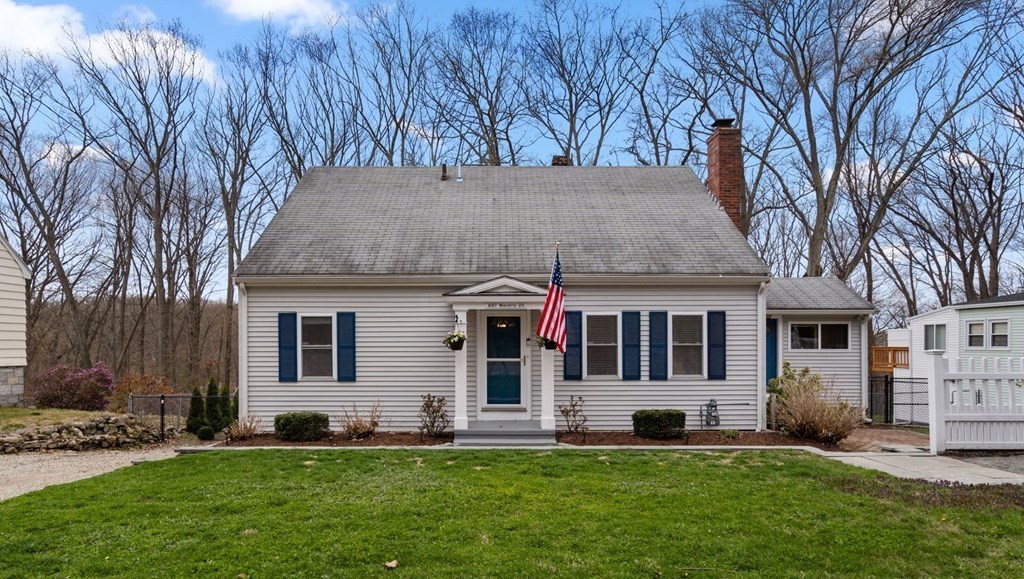 a front view of a house with a garden and yard