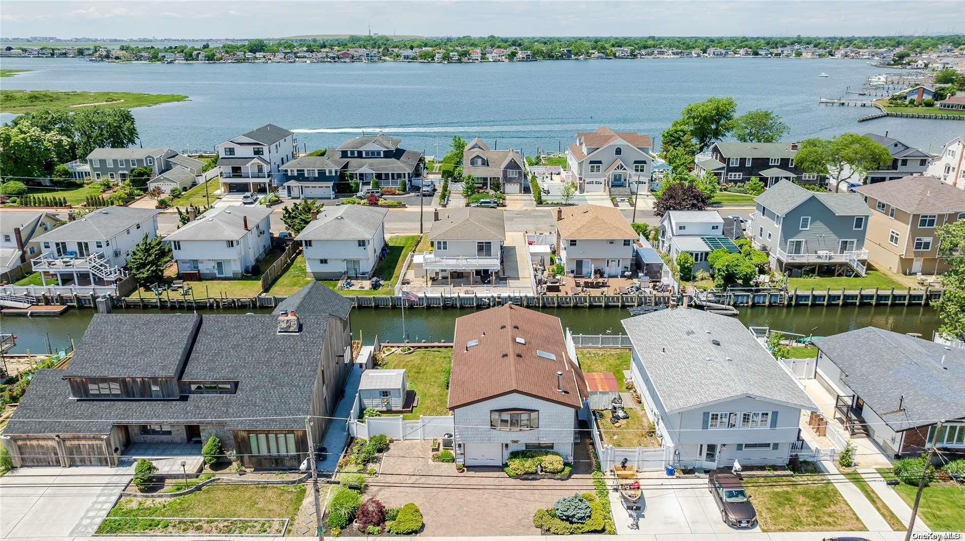 an aerial view of houses with outdoor space and lake view