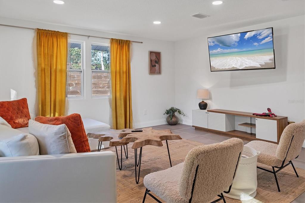 a living room with furniture and a large window