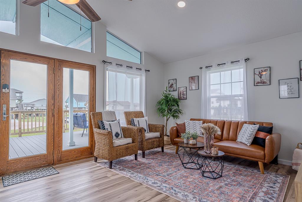 a living room with furniture and wooden floor