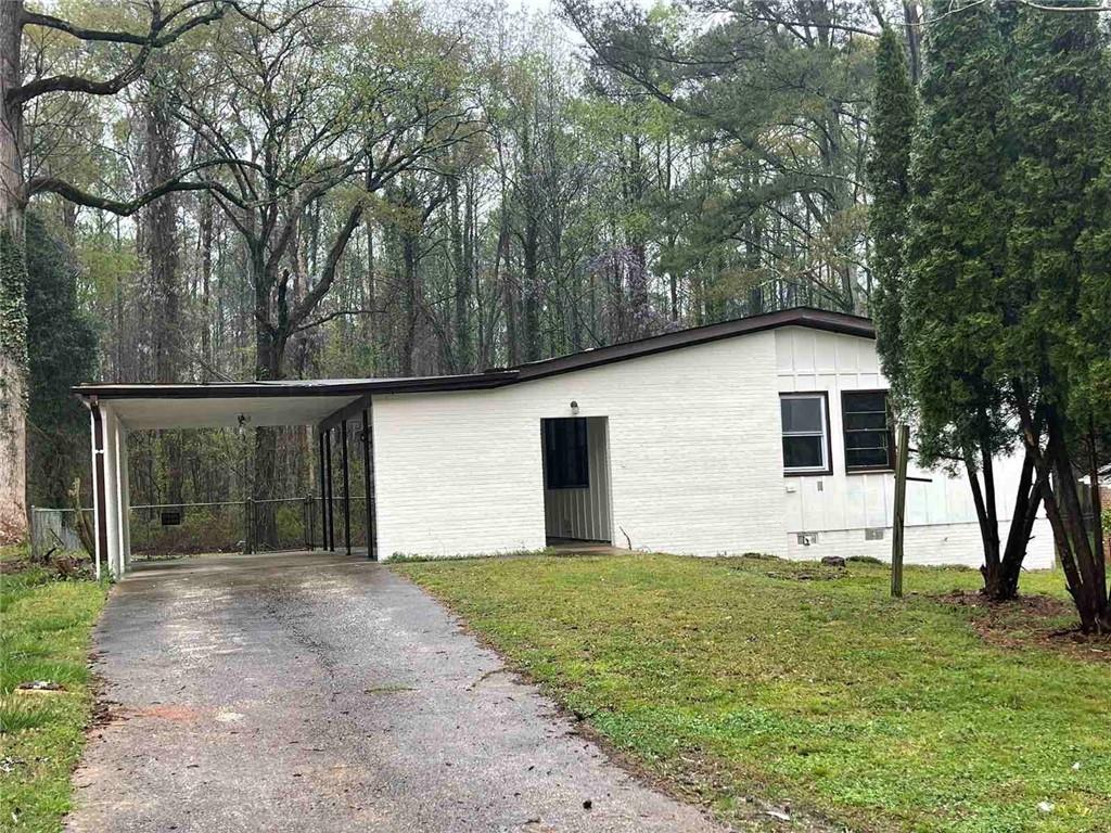 a front view of house with yard and trees