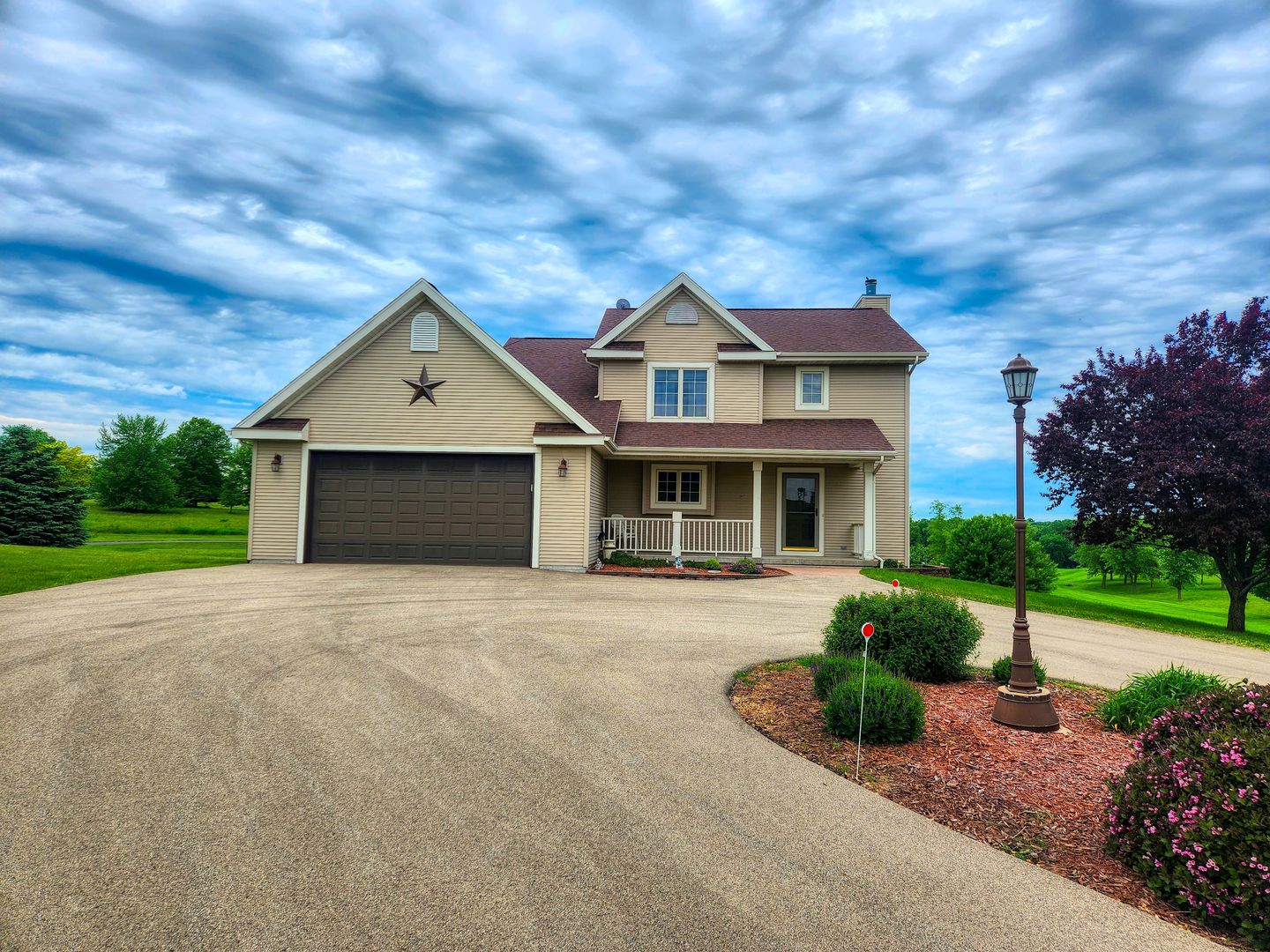 a front view of a house with a yard and garage