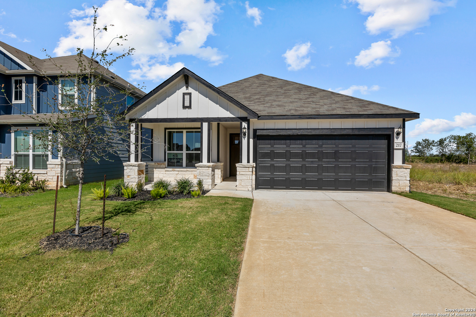 a front view of a house with a yard and garage