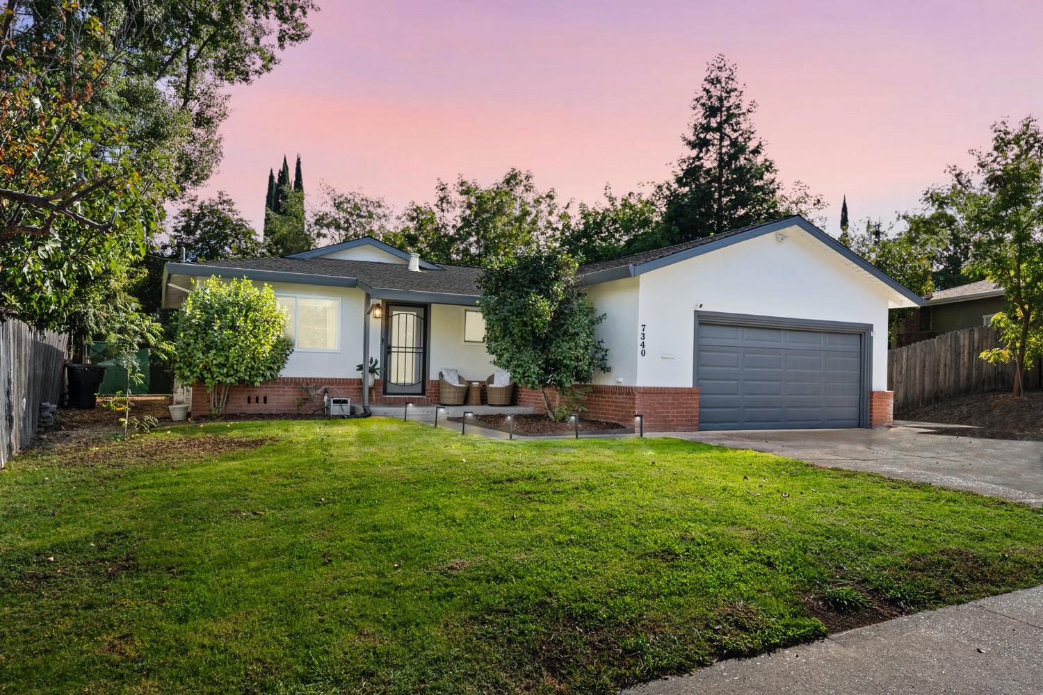 a front view of house with yard outdoor seating and green space