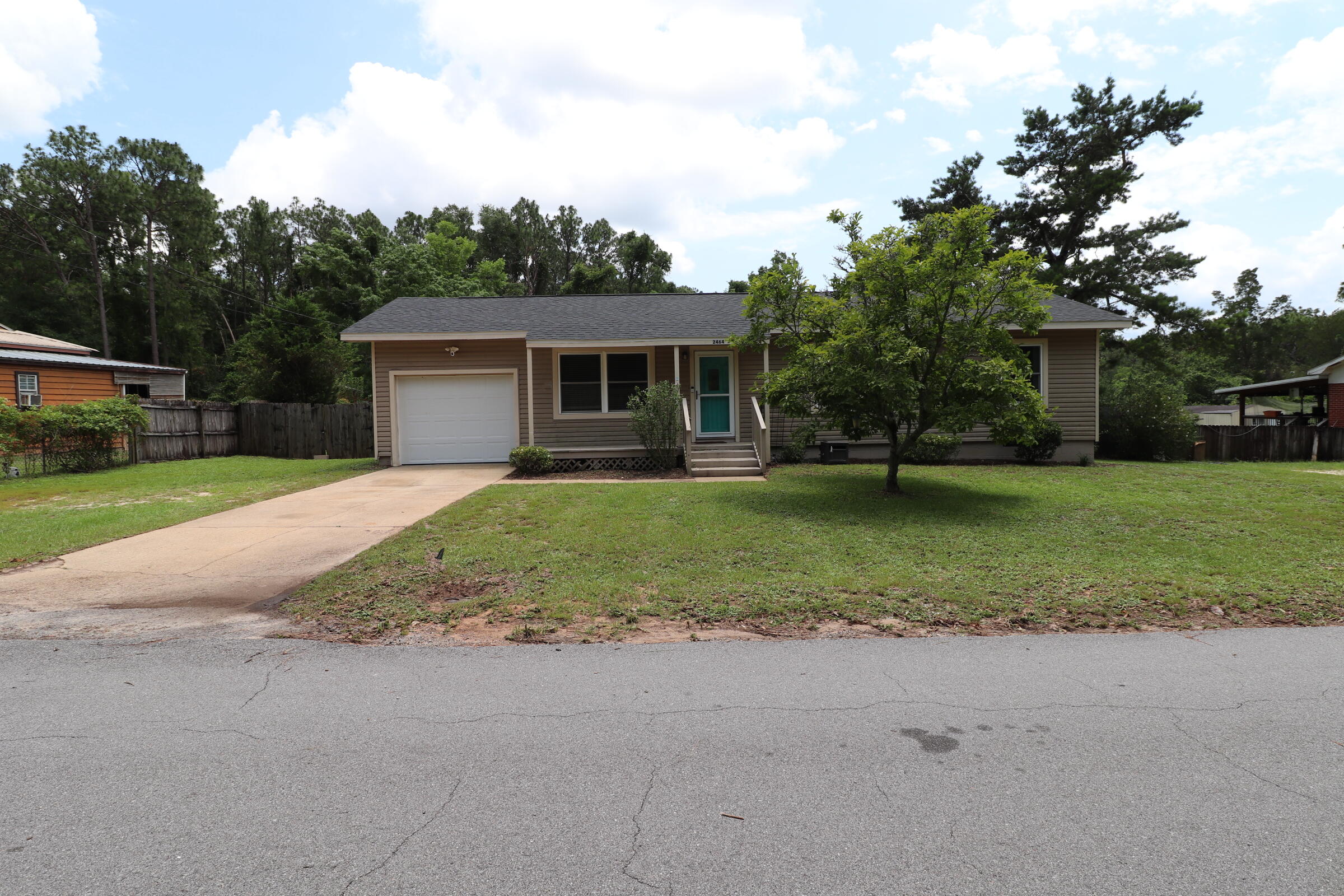 a front view of house with yard and green space