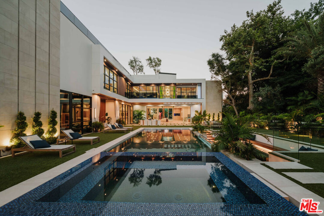 a view of a swimming pool with outdoor seating