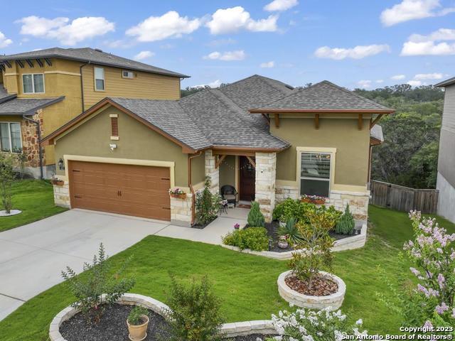 a front view of a house with yard and green space