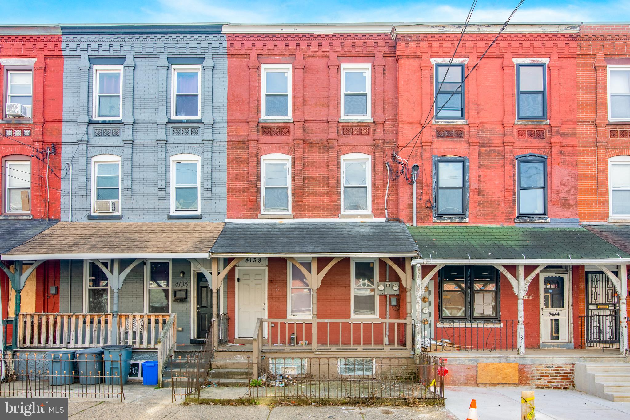 a front view of a residential apartment building with a yard