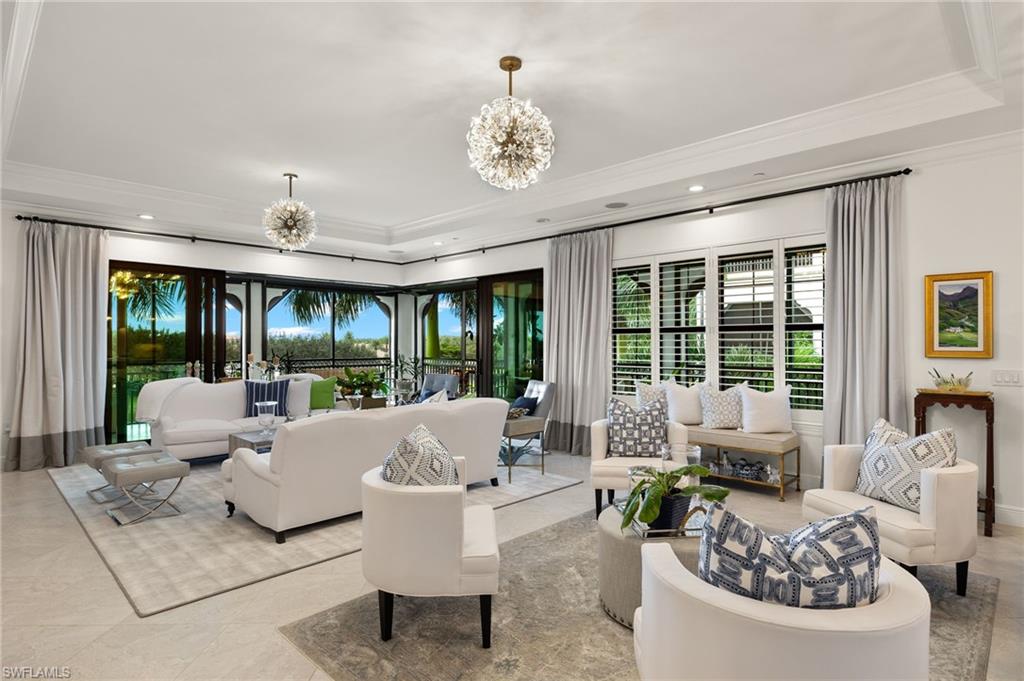 a living room with patio fireplace furniture and a chandelier