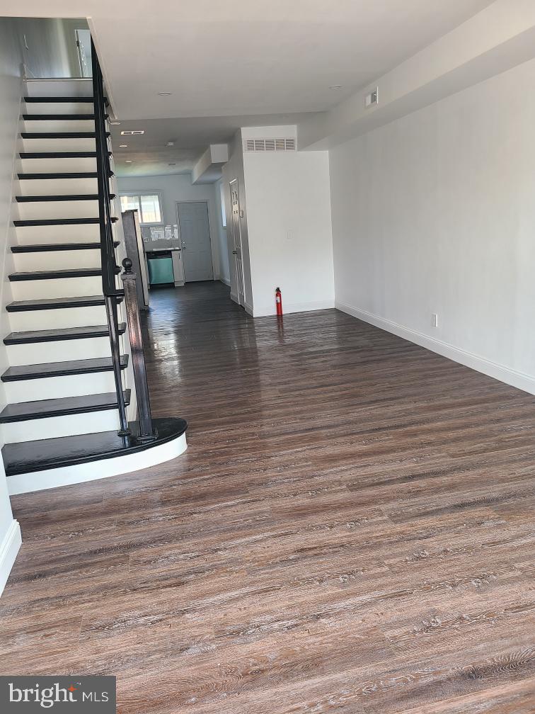 a view of a room with wooden floor