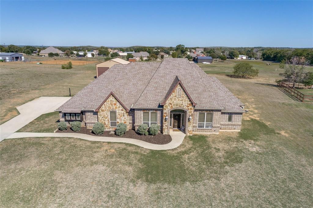 an aerial view of a house with a yard