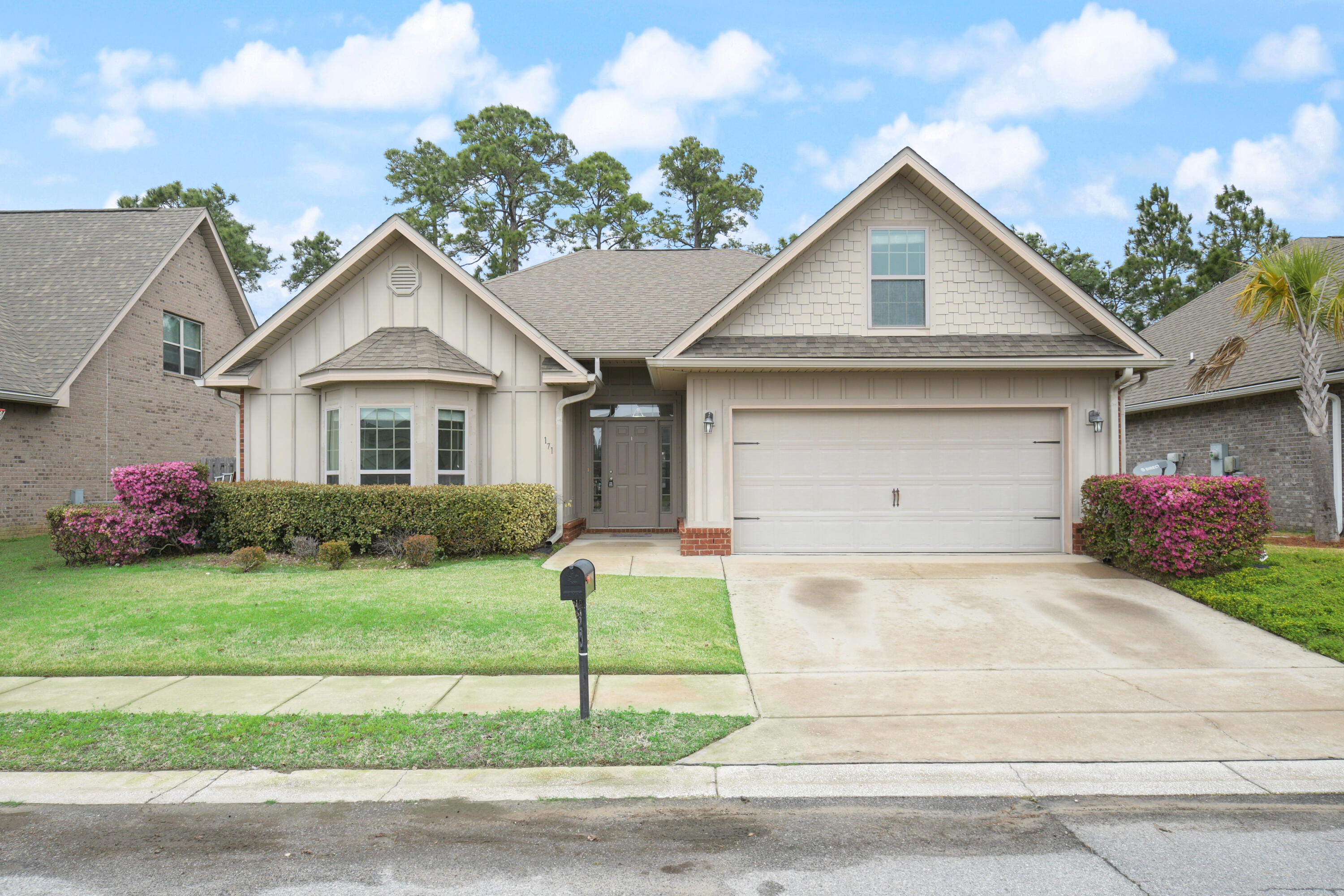 a front view of a house with a yard and garage