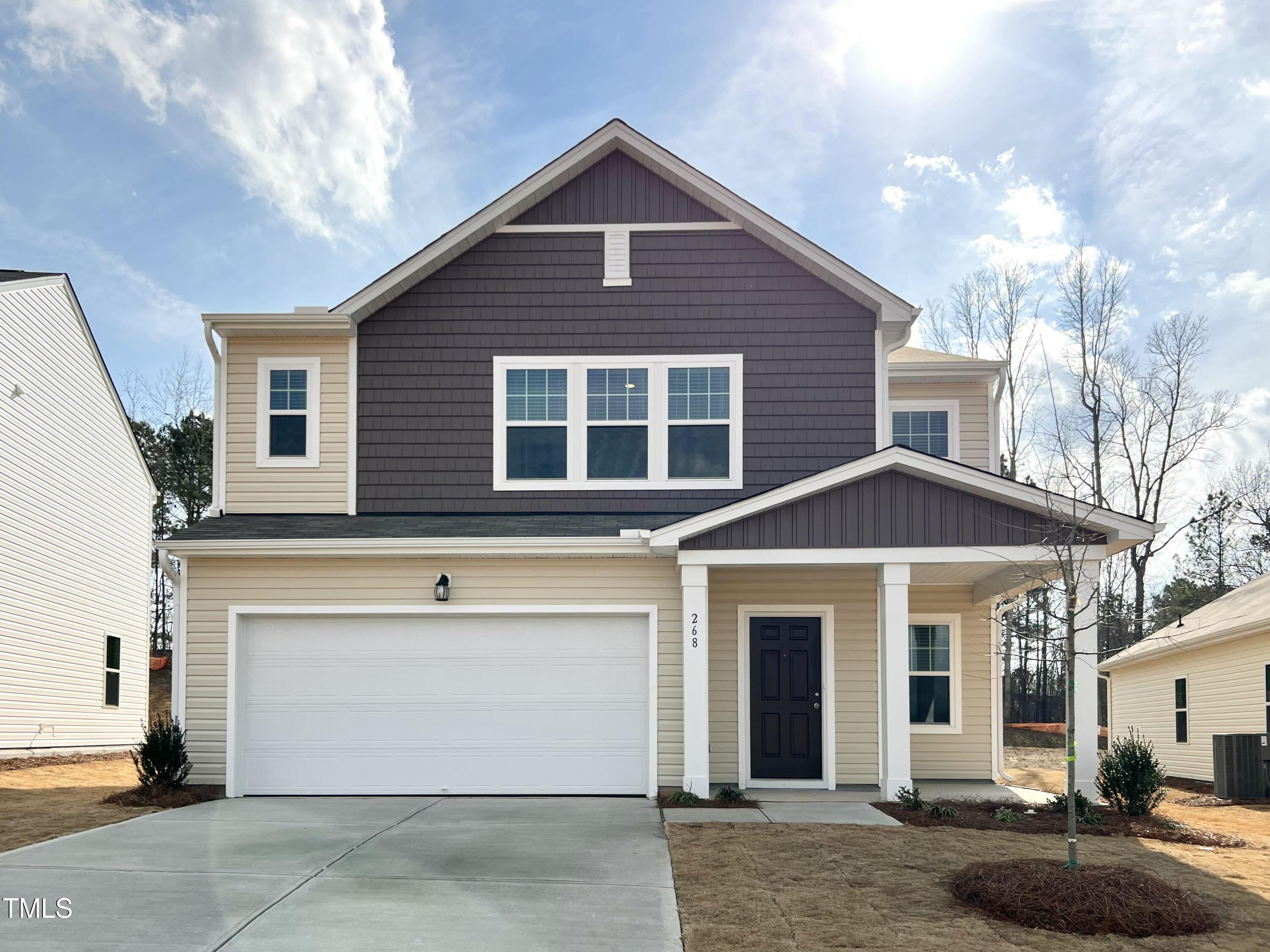 a front view of a house with garage and yard