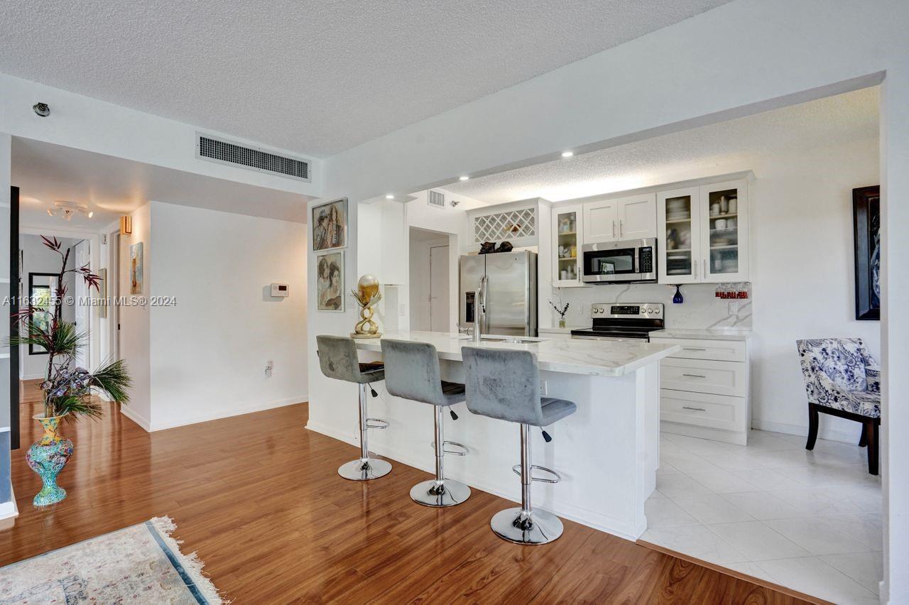 a living room with furniture a dining table and kitchen view