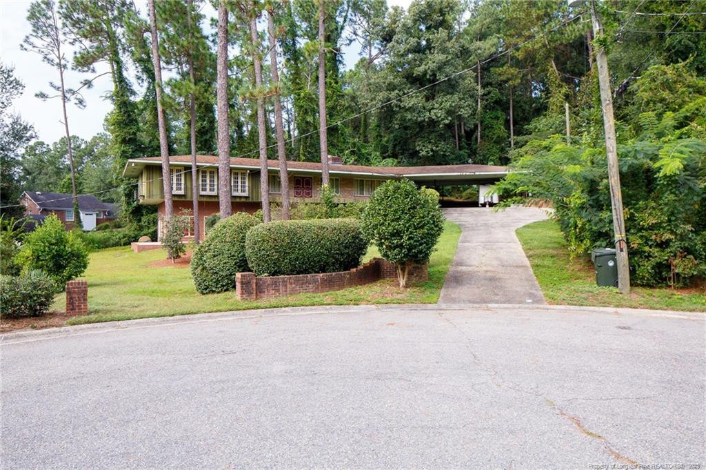 a view of house with outdoor space and garden