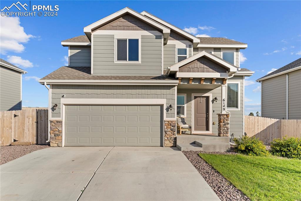 a front view of a house with a yard and garage