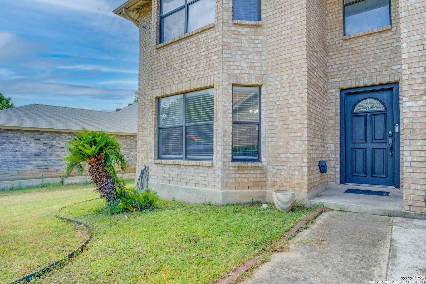 a front view of a house with garden