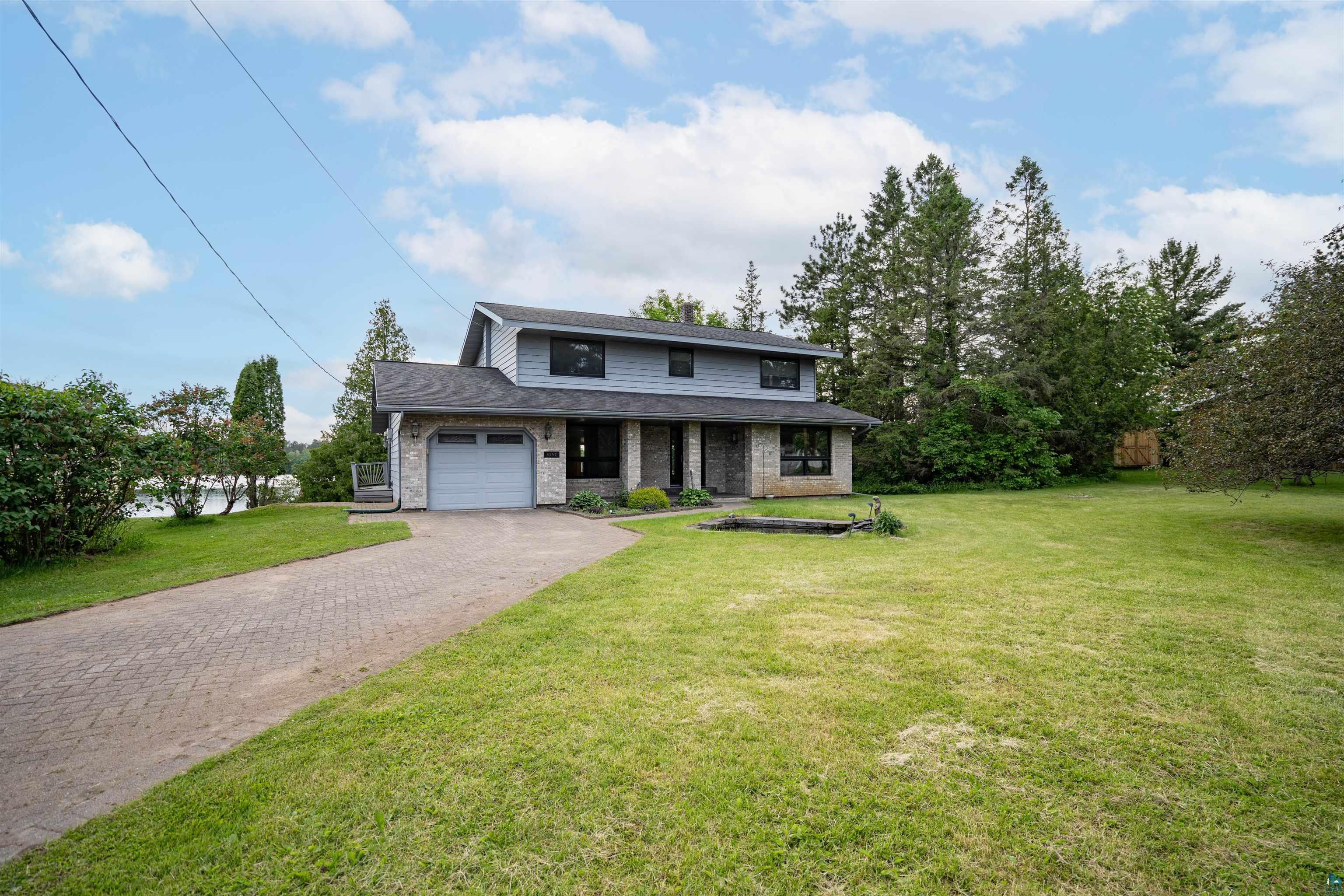 View of front of home featuring a front yard and a garage